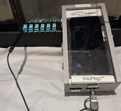 VisiMap Type 2 receive device: a generic smartphone in an enclosure with a wired 3.9mm USB otoscope camera plugged into a patch panel
